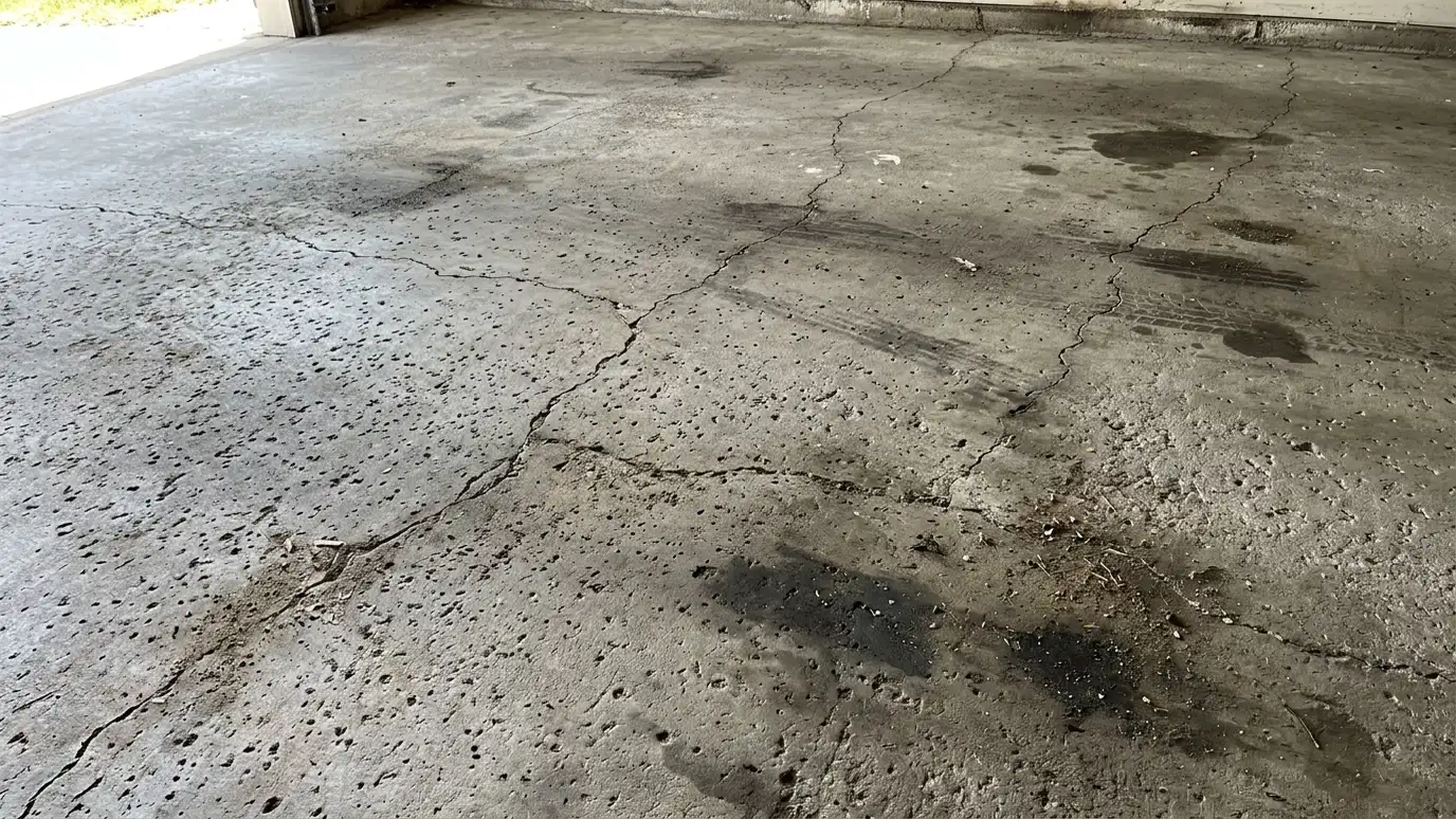 Before: a garage floor with an oil-stained, pitted garage floor